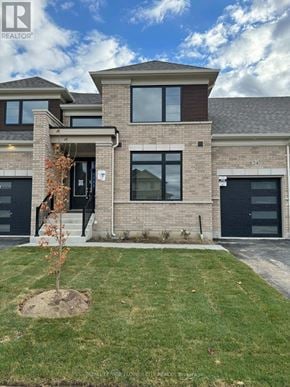 Adjala-Tosorontio (Colgan) townhouse for rent - A modern house with a tree in front of it.