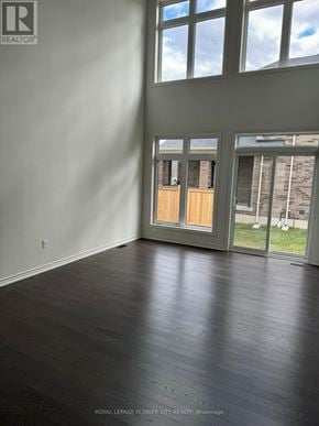 Adjala-Tosorontio (Colgan) townhouse for rent - A room with a wooden floor and a large window.
