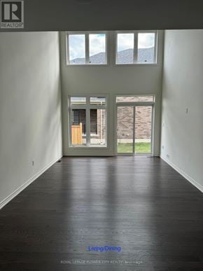 Adjala-Tosorontio (Colgan) townhouse for rent - A room with a wooden floor and a door leading to a balcony.