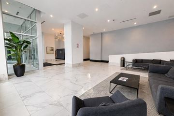 Surrey apartment for rent - A living room with grey couches and a black coffee table.