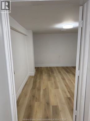 Windsor apartment for rent - A room with wooden flooring and white walls.