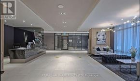 Toronto (Bayview Village) condo for rent - A spacious lobby with a reception desk and a couch.