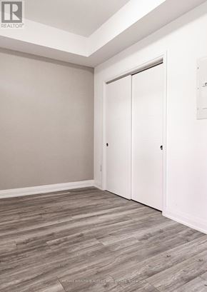 Toronto (Moss Park) multi-family for rent - A room with a sliding door and wood flooring.