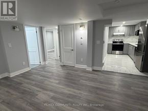 Oshawa (Eastdale) apartment for rent - A room with a grey floor and a white door.