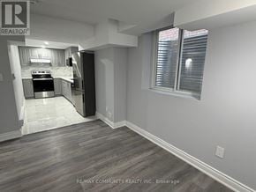 Oshawa (Eastdale) apartment for rent - A kitchen with a stove top oven and a refrigerator.