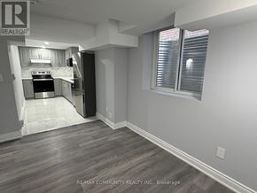Oshawa (Eastdale) apartment for rent - A modern kitchen with a stainless steel refrigerator and a marble countertop.