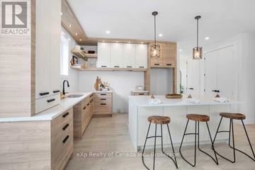 Norwich (Norwich Town) apartment for rent - A modern kitchen with wooden cabinets and a white island.