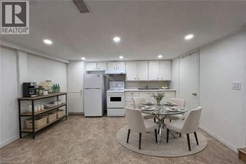 Kitchener apartment for rent - A well-lit kitchen with a dining table set for four.