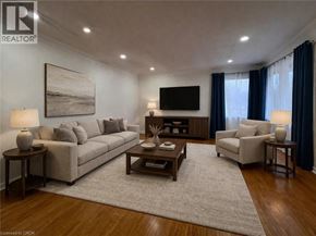 Kitchener apartment for rent - A living room with a grey couch, a coffee table, and a television.