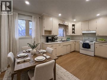 Kitchener apartment for rent - A well-lit kitchen with a dining table set for two.