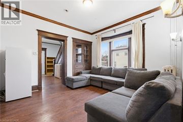 Waterloo apartment for rent - A living room with a grey couch and a white sideboard.