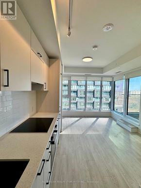 Toronto (Banbury-Don Mills) condo for rent - A tall building with many windows is the main focus of the image.