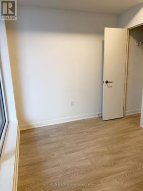 Toronto (Banbury-Don Mills) condo for rent - A room with a white door and wooden flooring.