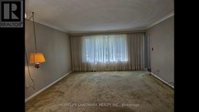 Toronto (Bendale) apartment for rent - A room with a lamp and a window with curtains.