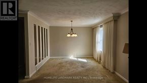 Toronto (Bendale) apartment for rent - A room with a carpet floor and a chandelier hanging from the ceiling.