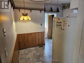 Toronto (Bendale) apartment for rent - A kitchen with a white fridge and a light hanging from the ceiling.
