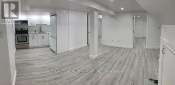 Toronto (Wexford-Maryvale) apartment for rent - A spacious room with a kitchen area and a dining table.