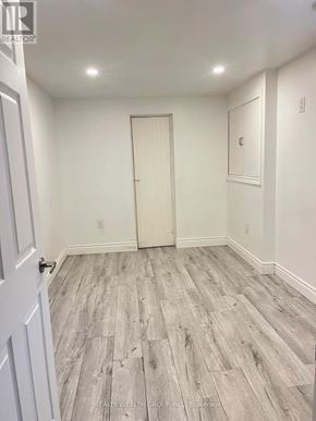 Toronto (Wexford-Maryvale) apartment for rent - A room with a white door and grey wood flooring.