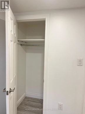 Toronto (Wexford-Maryvale) apartment for rent - A white door with a handle and a wall with a switch.