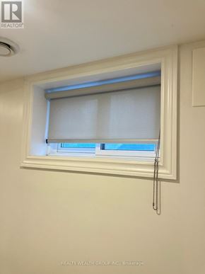 Toronto (Wexford-Maryvale) apartment for rent - A window with white blinds and a curtain is in a white room.