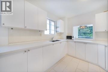 Vancouver apartment for rent - A white kitchen with a microwave and oven built in.