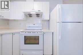 Vancouver apartment for rent - A white kitchen with a stove, oven, and refrigerator.