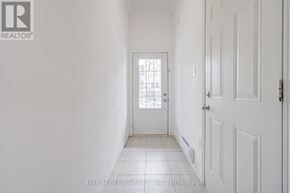Oshawa (Windfields) townhouse for rent - A white hallway with a door at the end.