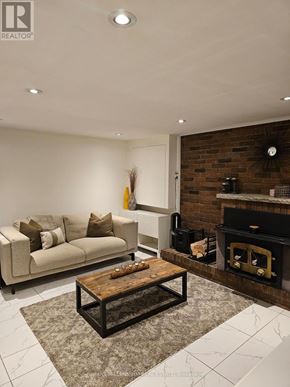 Toronto (Mount Olive-Silverstone-Jamestown) apartment for rent - A living room with a fireplace and a couch.