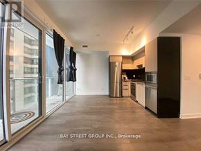Toronto (Church-Yonge Corridor) condo for rent - A spacious kitchen with a refrigerator, oven, and sink.