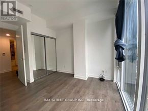 Toronto (Church-Yonge Corridor) condo for rent - A room with a sliding glass door and a black bag on the floor.