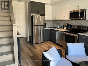 Toronto (Willowdale West) townhouse for rent - A modern kitchen with a refrigerator, stove, and oven.