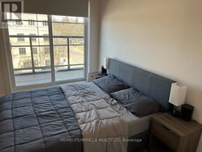 Toronto (Willowdale West) townhouse for rent - A bedroom with a large bed and a window overlooking a balcony.