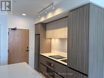 Vaughan (Beverley Glen) condo for rent - A modern kitchen with wooden cabinets and a white countertop.
