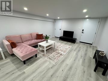 Aurora (Aurora Highlands) apartment for rent - A living room with a pink couch and a white coffee table.
