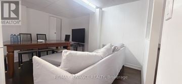 Toronto (Parkwoods-Donalda) apartment for rent - A living room with a white couch and a wooden table.