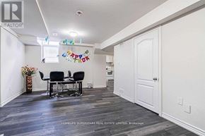 Brampton (Brampton South) apartment for rent - A room with a dining table and chairs with a sign that says "Happy Birthday" hanging on the wall.