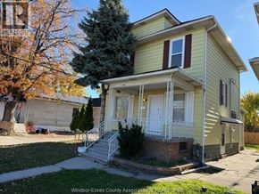 Windsor apartment for rent - A two-story house with a front porch and a tree in front.