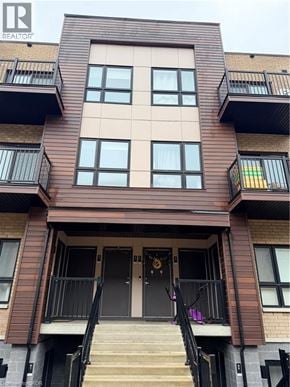 Kitchener townhouse for rent - A brown building with a black door and windows.