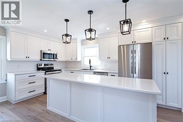 Townsend apartment for rent - A modern kitchen with white cabinets and a central island.