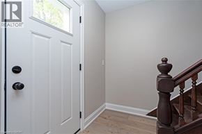 Townsend apartment for rent - A white door with a black handle is on the left and a wooden staircase is on the right.