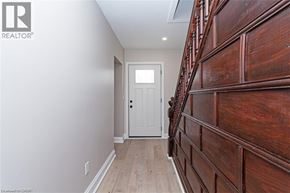 Townsend apartment for rent - A hallway with a white door and wooden stairs.