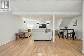 Adjala-Tosorontio (Lisle) apartment for rent - A living room with a white couch and a television.
