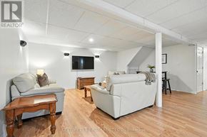 Adjala-Tosorontio (Lisle) apartment for rent - A living room with a grey couch, a white couch, and a wooden table.