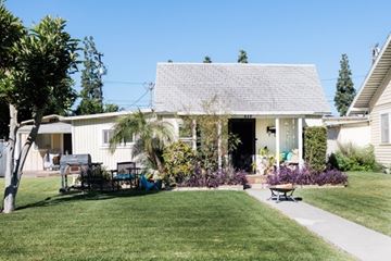 Fullerton apartment for rent - A house with a white front porch and a green lawn.