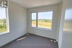 Cobourg townhouse for rent - A room with a large window overlooking a field.