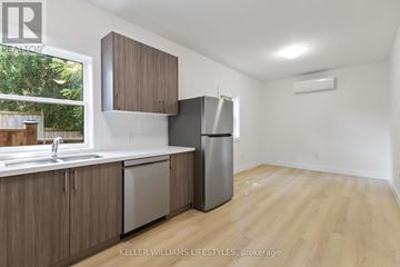 London North (North N) apartment for rent - A kitchen with wooden cabinets and a stainless steel refrigerator.