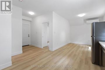 London North (North N) apartment for rent - A kitchen area with a refrigerator and wooden flooring.