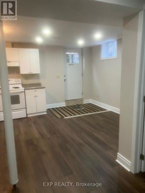 Ajax (Central West) apartment for rent - A room with wooden floors and white walls.