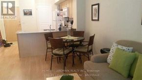 Markham (Unionville) condo for rent - A living room with a dining table and chairs.