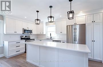Norfolk (Townsend) apartment for rent - A modern kitchen with white cabinets and a central island.